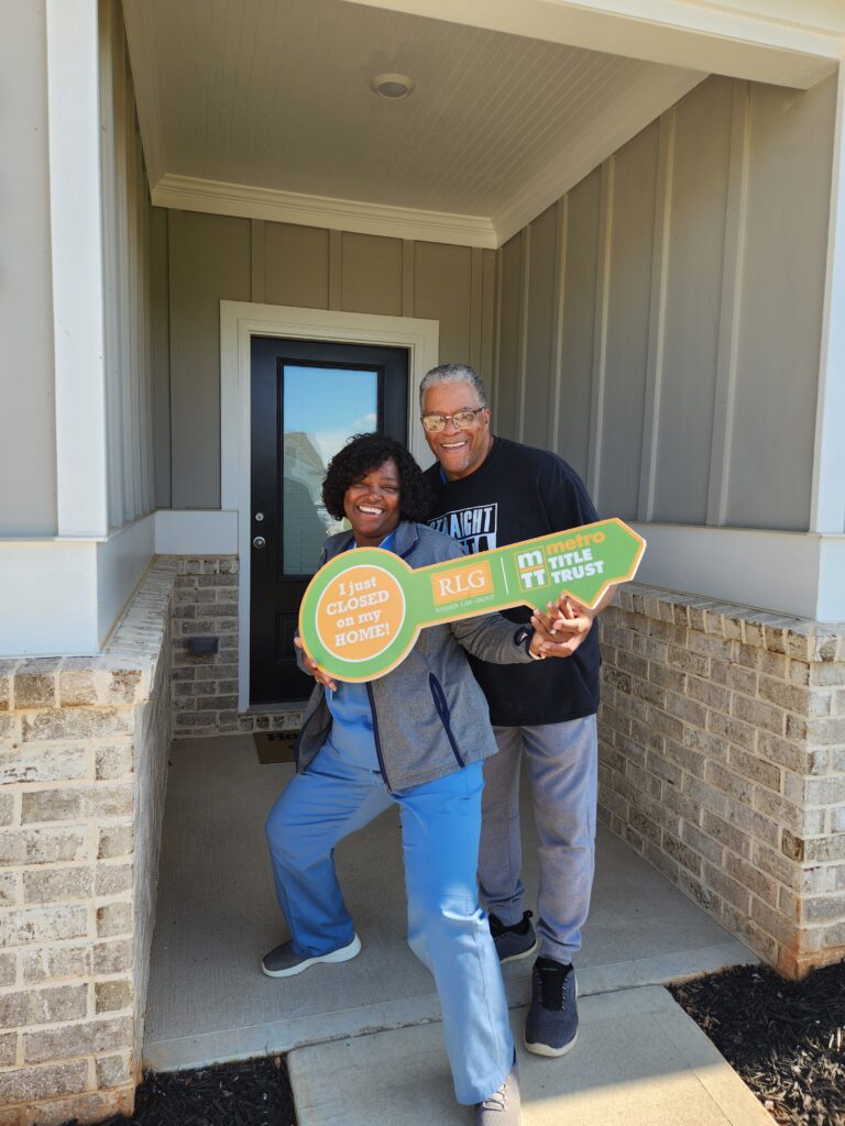 A couple holding a large key reading I just closed.